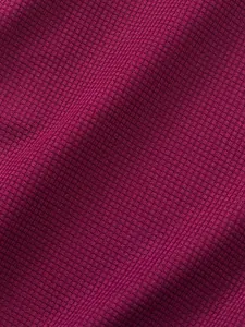 Macro detail of breathable burgundy waffle knit fabric texture on men's casual t-shirt