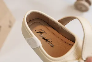 Close-up detail of girls cream leather princess shoes with soft cushioned insole