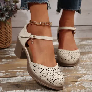 Detailed view of elegant cream laser-cut Mary Jane pumps with a stylish chunky heel.