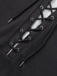 Close-up detail of men's waffle knit t-shirt with lace-up design and metal eyelets