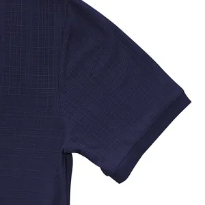 Macro detail of navy blue vintage slub fabric texture on a men's short sleeve shirt