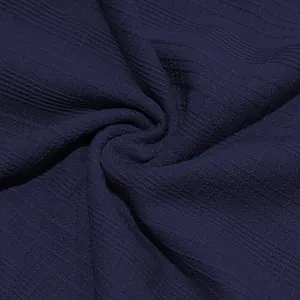 Close-up view of navy blue slub cotton fabric texture and premium drape for men's shirt