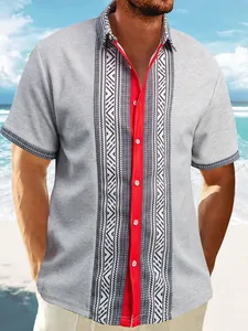 Detail of grey waffle knit men's shirt with tribal print and vibrant red placket