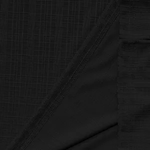 Macro detail showing the breathable black slub fabric texture for casual men's summer shirt