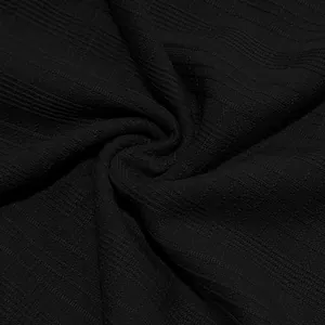 Macro close-up detail of black slub fabric texture showing retro knit patterns for men's shirt