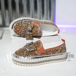 Close-up of sparkling rhinestone loafers featuring 3.5cm platform sole and bow