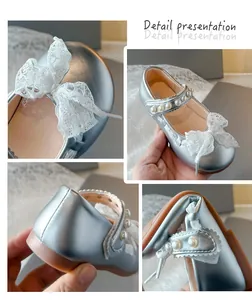 Detailed view of silver girls' Mary Jane shoes with lace bow and pearl strap details.