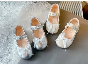 Detailed view of girls' Mary Jane shoes with lace bows and pearl straps in two colors