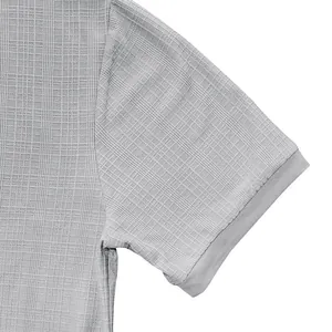 Close-up view showing the slub texture and sleeve detail of a light grey Henley shirt