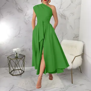 Full-length view of a vibrant green one-shoulder maxi dress with a waist tie and high slit.