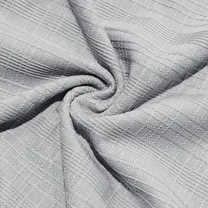 Macro view of light gray slub knit fabric texture showing high-quality fine weave details