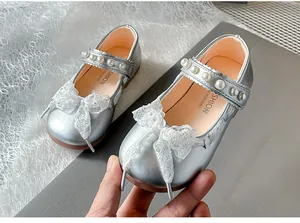 Silver girls' Mary Jane shoes featuring a delicate lace bow and pearl-embellished strap.