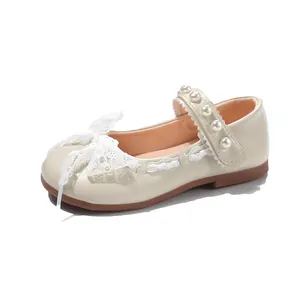 Elegant girls cream Mary Jane shoes with lace bow and pearl embellished strap detail