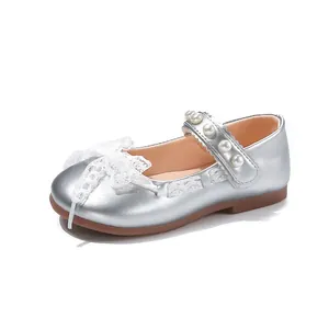 Detailed view of girls' silver Mary Jane shoes with lace bow and elegant pearl strap decoration