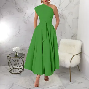 Elegant one-shoulder green maxi dress with belted waist in a luxury marble setting