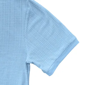 Close-up of light blue slub fabric texture on a men's casual short-sleeved Henley shirt.