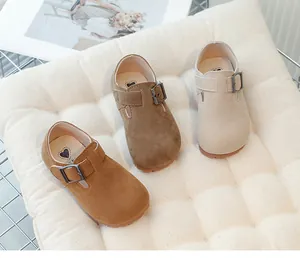 Close-up of children's suede Mary Jane shoes in three shades of brown