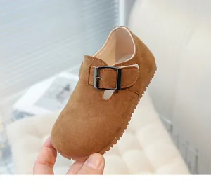 Close-up of vintage brown suede T-strap shoes for children with an adjustable buckle