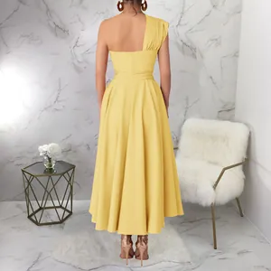 Back view of a elegant yellow one-shoulder sleeveless flared midi dress in a chic room