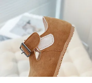 Detailed macro shot of children's brown suede Mary Jane shoe with velcro strap and buckle closure
