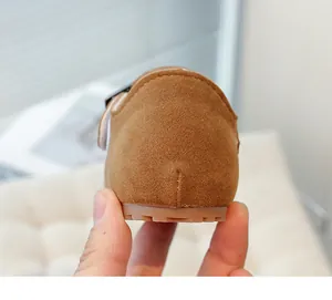 Rear view detail of brown suede vintage loafers for children showing heel and sole