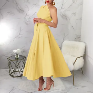Elegant one-shoulder yellow maxi dress with belted waist and side slit in indoor setting.