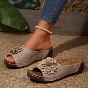Vista lateral detallada de sandalias de cuña color beige con elegante adorno floral