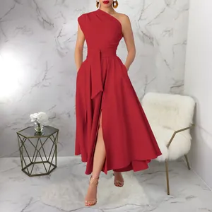 Model wearing a red one-shoulder sleeveless dress with a high slit and waist tie detail