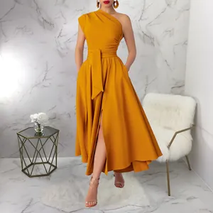 Detail view of a ginger one-shoulder sleeveless dress with waist tie and high slit.