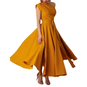Detail view of mustard yellow one-shoulder dress showing flared skirt and waist tie