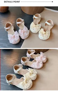 Detail view of girl's princess sandals with large lace bows and adjustable ankle straps