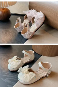 Detail view of girl's princess sandals featuring sparkling mesh bowknots and pearl charms.