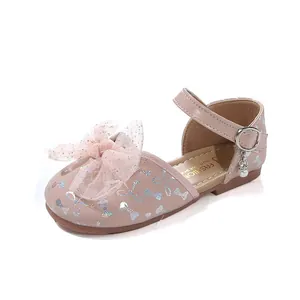 Detailed view of pink girls princess sandals with mesh bow and pearl charm