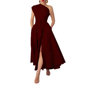 Detailed view of an elegant wine red one-shoulder maxi dress with a waist tie and high slit.