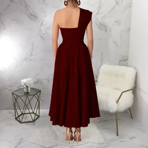 Back view of a burgundy one-shoulder flared maxi dress with a cinched waistline