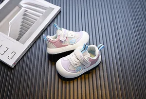 Detailed view of pink and purple baby walking shoes with soft mesh and Velcro straps.