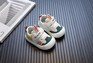 Detail view of breathable mesh baby walking shoes with green and yellow accents