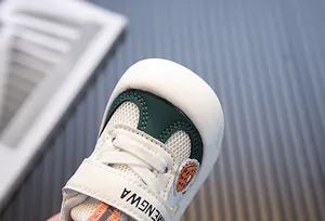 Close-up of breathable mesh toddler shoes with reinforced toe cap and Velcro strap