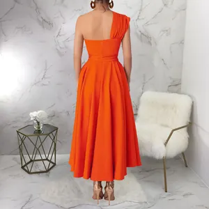 Back view of elegant orange one-shoulder sleeveless maxi dress with flared long skirt