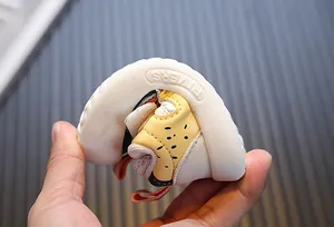 Close-up showing the soft and flexible sole of a toddler walking shoe for babies.