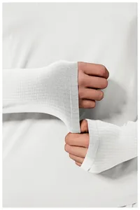 Detail view of thumbhole cuffs on a white seamless long sleeve athletic compression shirt.