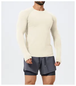 Front view of a men's seamless long-sleeved sports T-shirt in cream on a model.