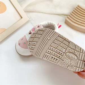 Close-up detail of the anti-slip textured rubber sole on pink strawberry baby walking shoes