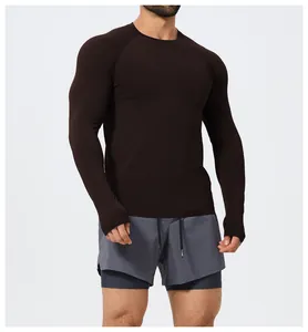 Detail of a men's dark brown seamless long sleeve athletic slim fit training shirt