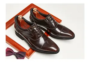 Detailed view of dark brown glossy leather Oxford shoes with British style design