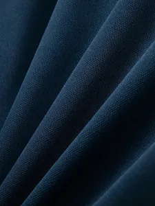 Macro view of dark blue breathable pique knit fabric texture for men's casual polo shirt