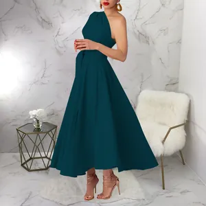Detail view of an elegant dark teal one-shoulder sleeveless maxi dress with a flared hem