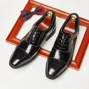 Elegant men's glossy black Oxford dress shoes with British style cap-toe design.