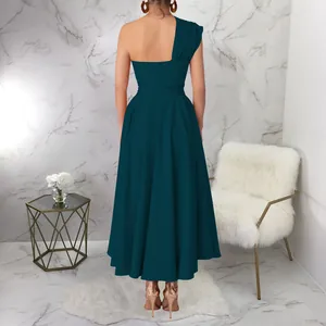 Detailed back view of a teal one-shoulder maxi dress featuring a flowy pleated skirt