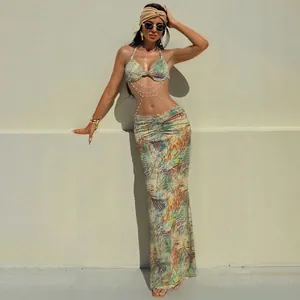 Full length detail of sexy tropical print halter dress with pearl chain decoration